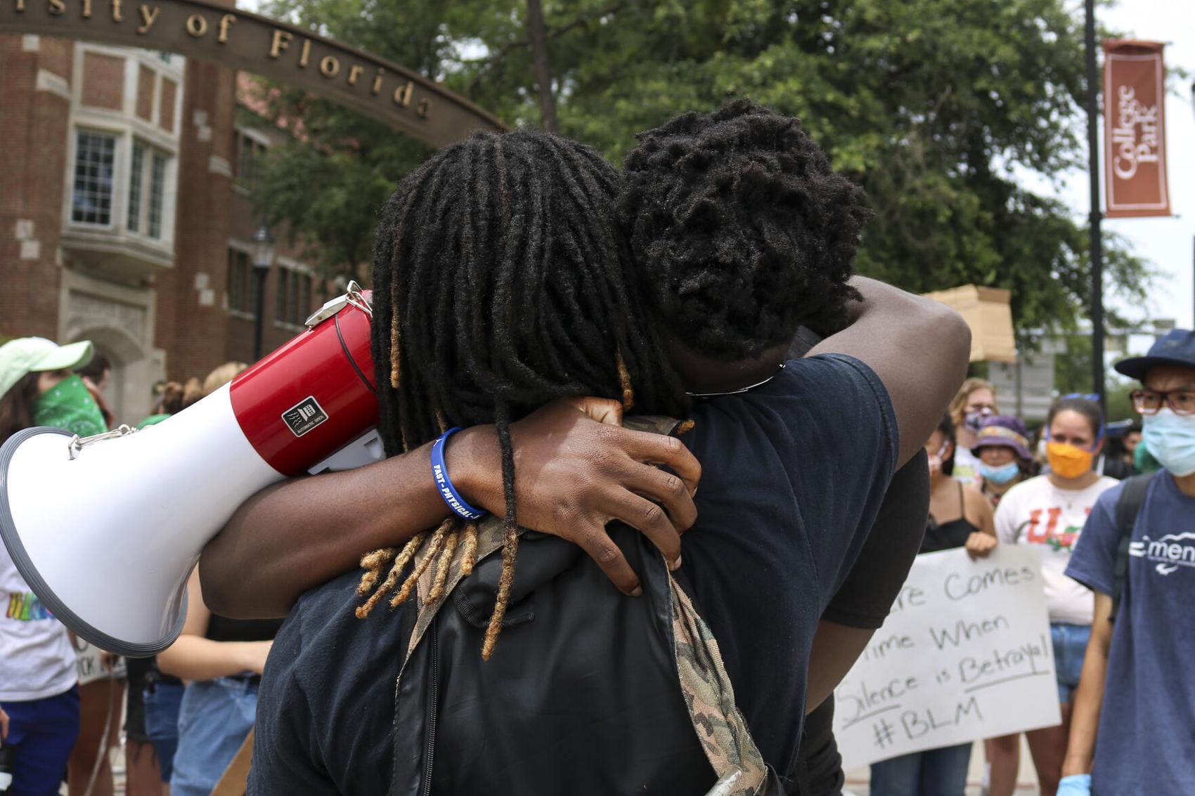 Protestors hug at demonstration