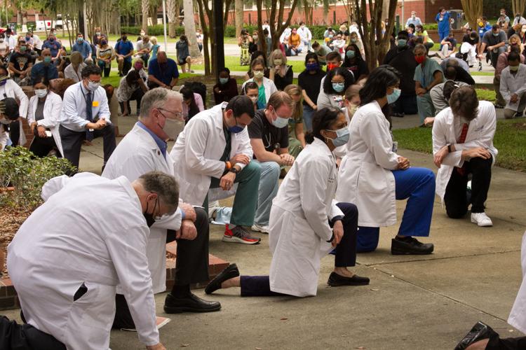 UF Health faculty, staff and students kneel
